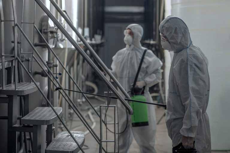 cleaning-and-disinfection-at-work-guys-in-protective-suits-and-glasses-work-in-plant